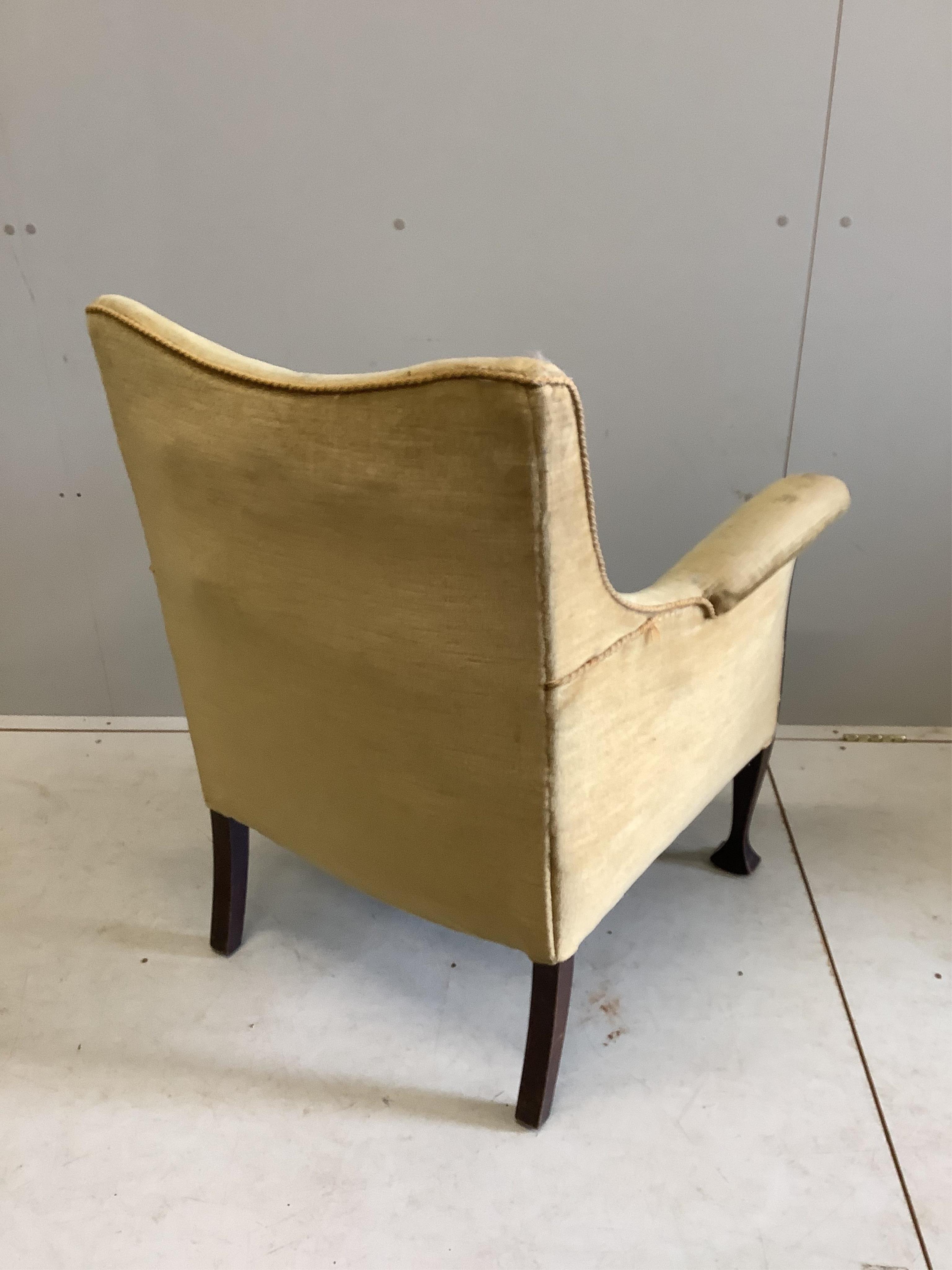 An Edwardian carved mahogany upholstered armchair, width 70cm, depth 61cm, height 91cm. Condition - fair, upholstery poor